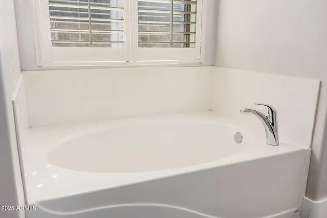 a white bath tub sitting next to a window