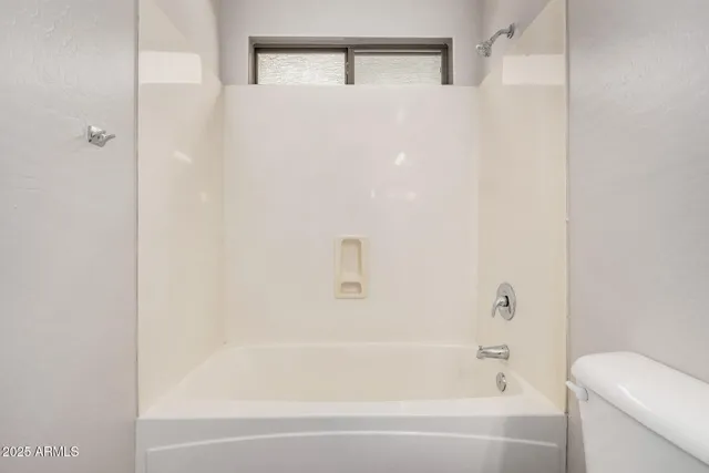 a bathroom with a bathtub and a toilet