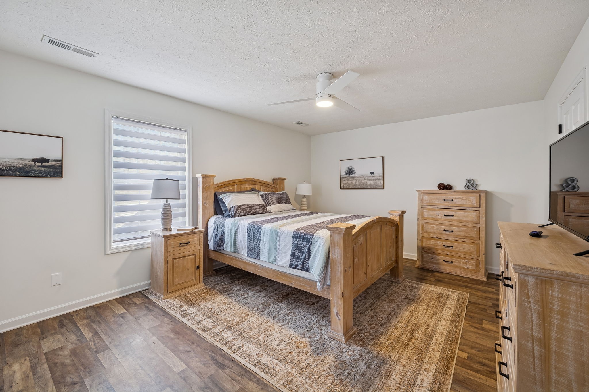 814 Denning Ford Road Portland, TN 37148 - Photo 40 of 99 a bedroom with a bed and a flat tv screen