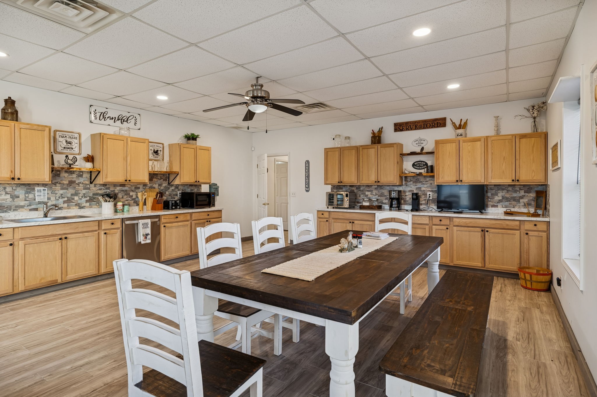 814 Denning Ford Road Portland, TN 37148 - Photo 72 of 99 a kitchen with a sink stove cabinets and wooden floor