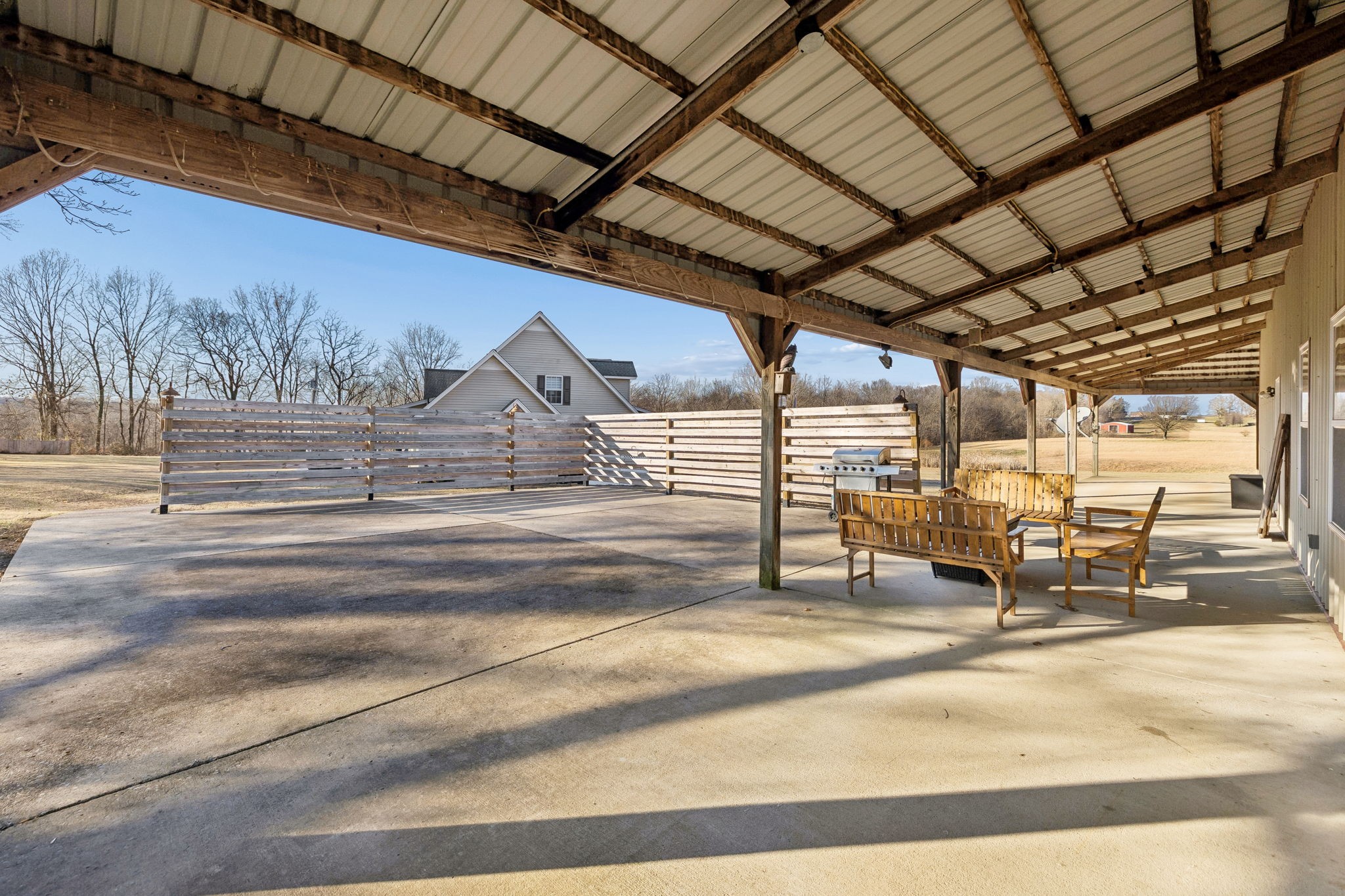 814 Denning Ford Road Portland, TN 37148 - Photo 84 of 99 a view of a patio with table and chairs with wooden floor