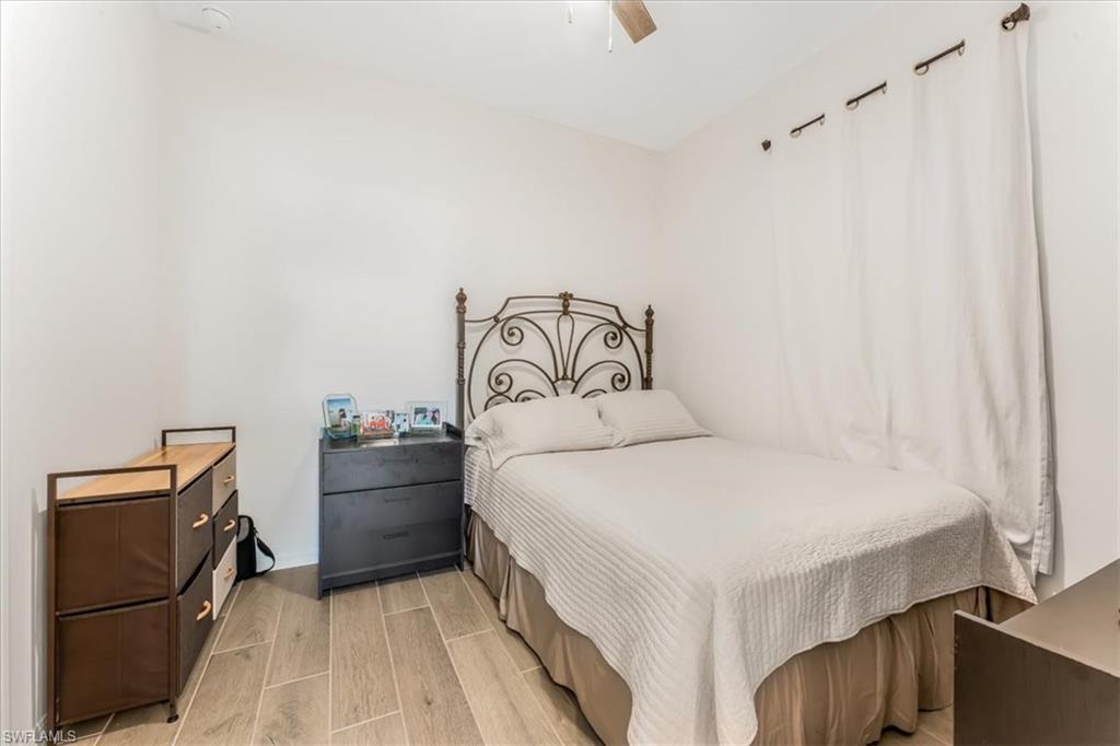 2581 Kona Way Naples, FL 34120 - Photo 14 of 35 a bedroom with a bed and a refrigerator