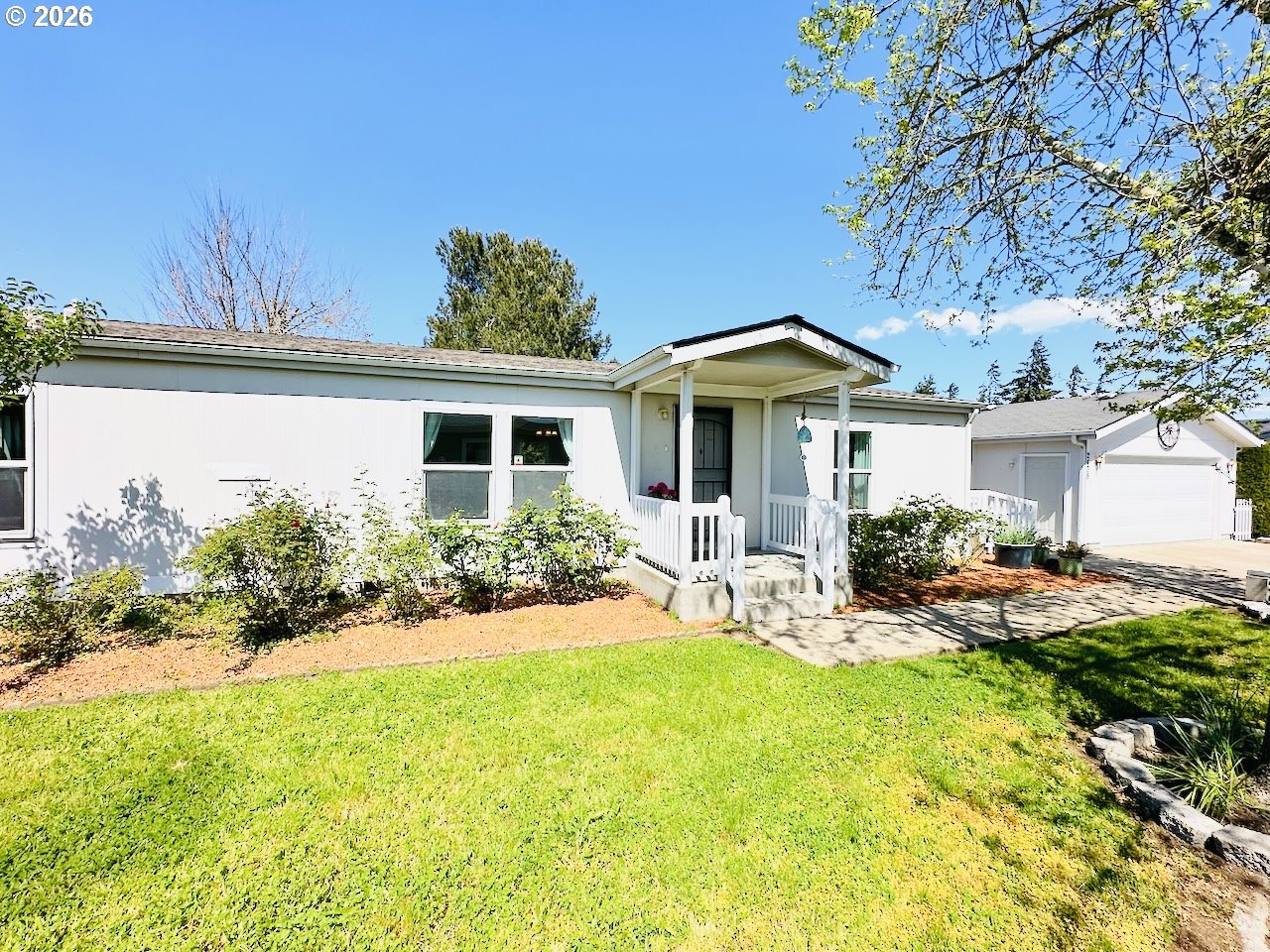 2438 Maia Loop Springfield, OR 97477 - Photo 27 of 32 a front view of a house with yard patio and swimming pool