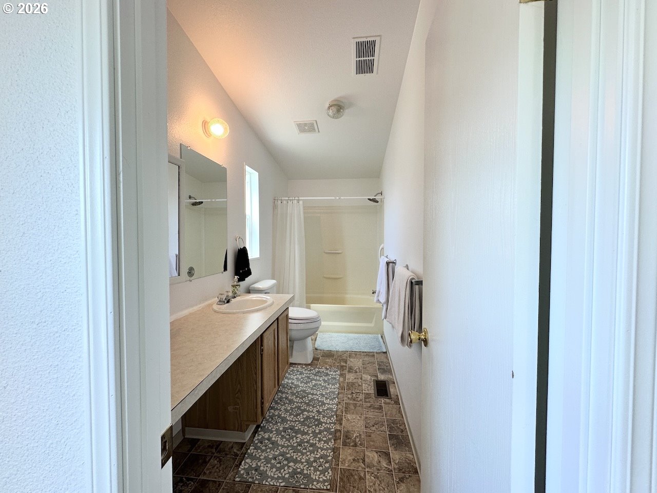 2438 Maia Loop Springfield, OR 97477 - Photo 28 of 32 a bathroom with a double vanity sink and mirror with shower