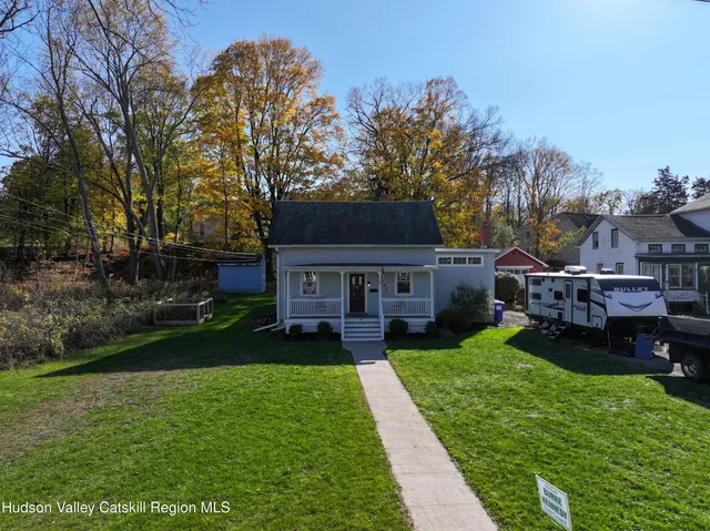 a view of house with backyard and patio