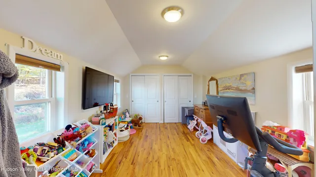 a bed room with furniture and a flat screen tv