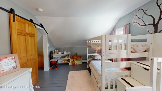 a view of a bedroom with workspace and a window