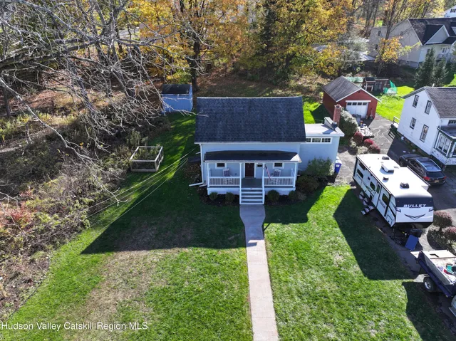 an aerial view of a house with a garden and parking space