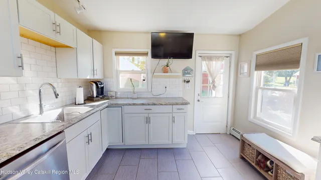 a kitchen with a sink and a refrigerator