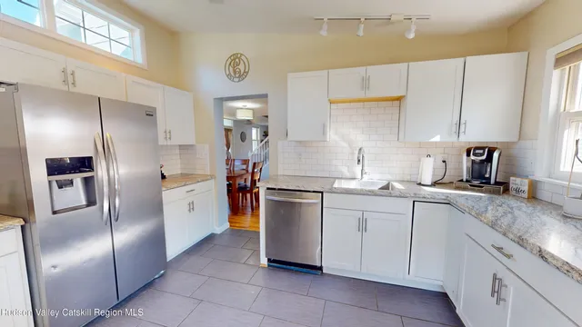 a kitchen with stainless steel appliances granite countertop a refrigerator sink and cabinets