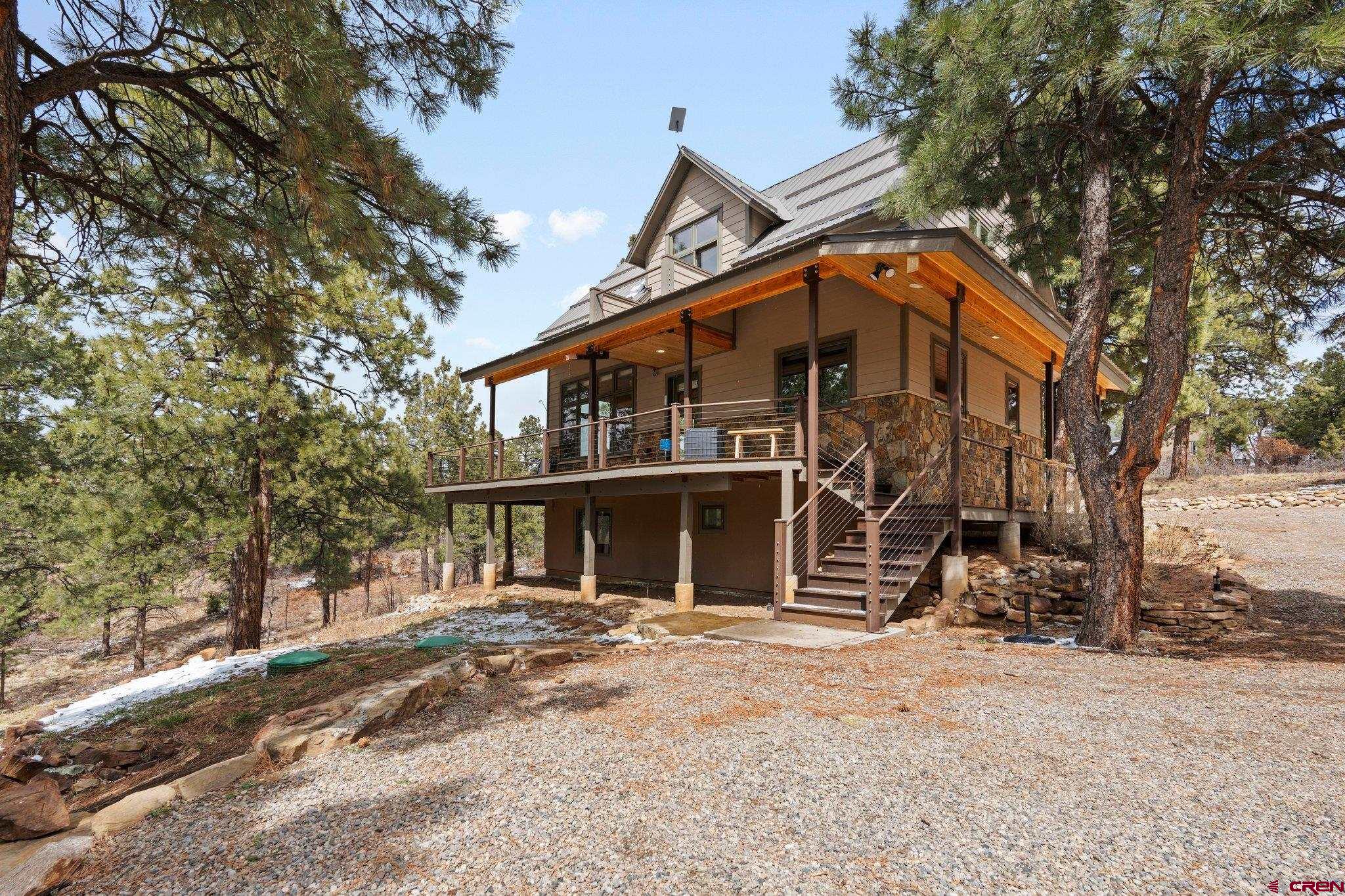 855 Ridge Road Durango, CO 81303 - Photo 1 of 35 a front view of a house with a tree