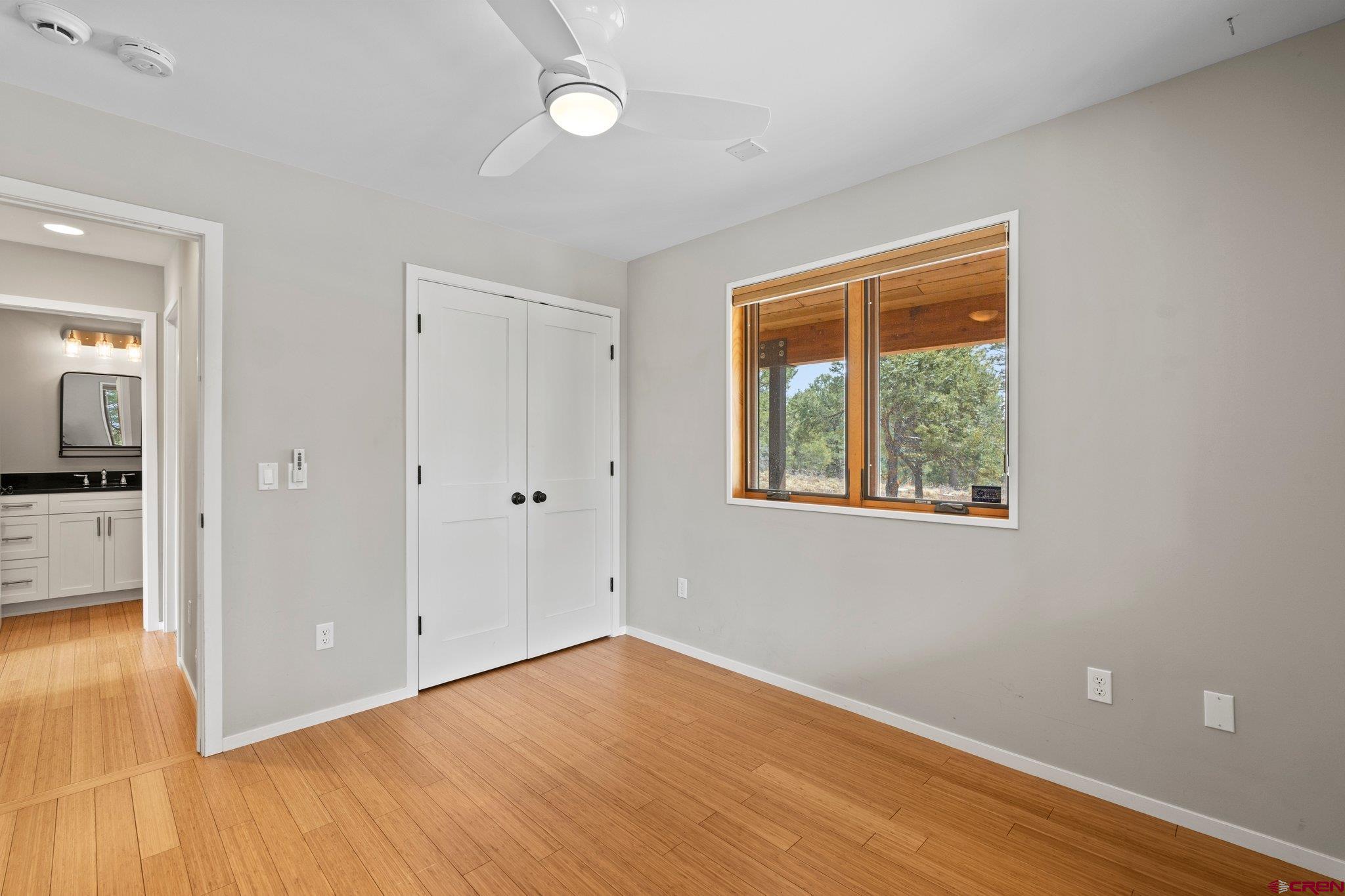 855 Ridge Road Durango, CO 81303 - Photo 16 of 35 a view of an empty room with wooden floor and a window
