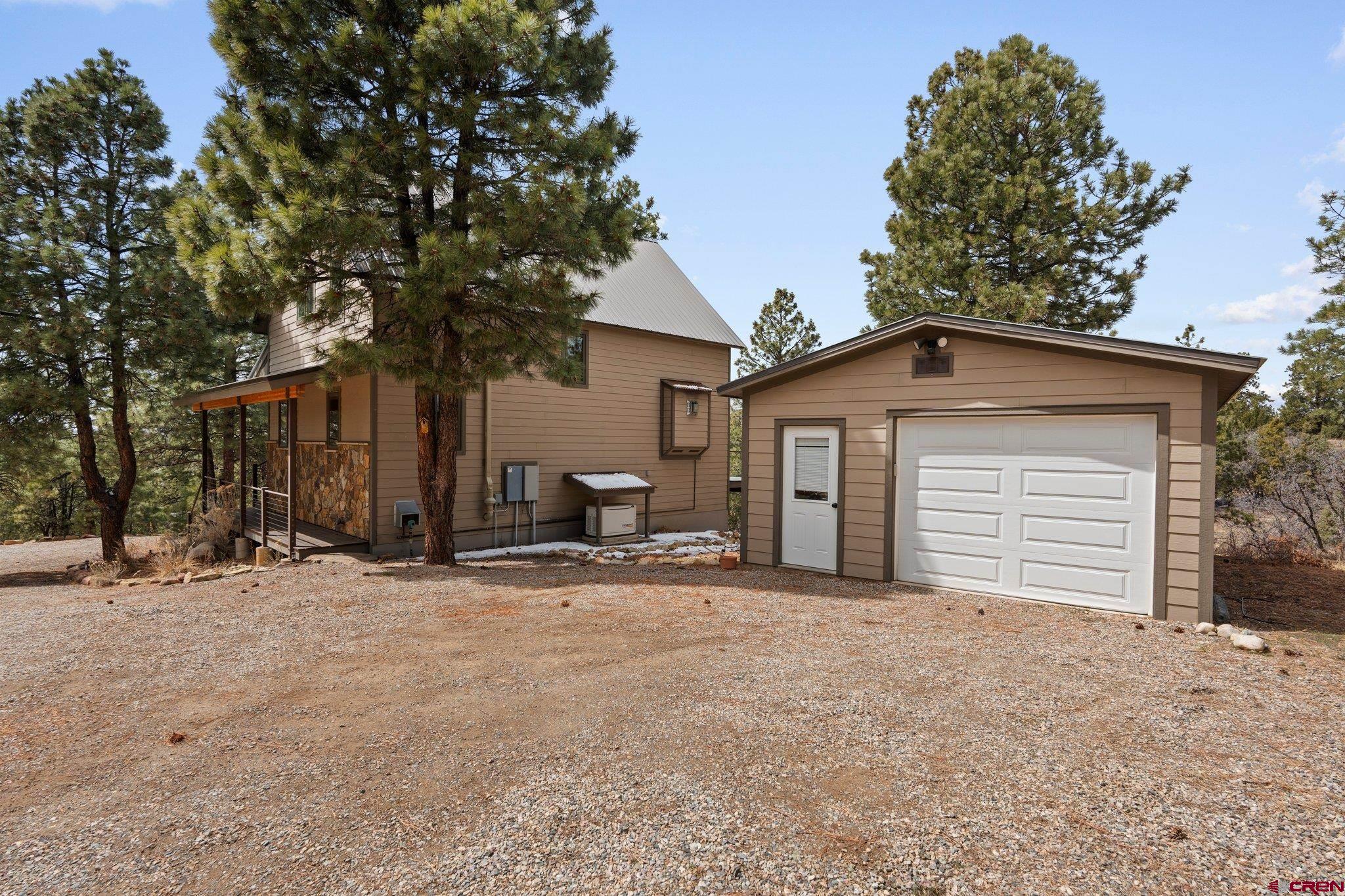 855 Ridge Road Durango, CO 81303 - Photo 30 of 35 a house with trees in the background