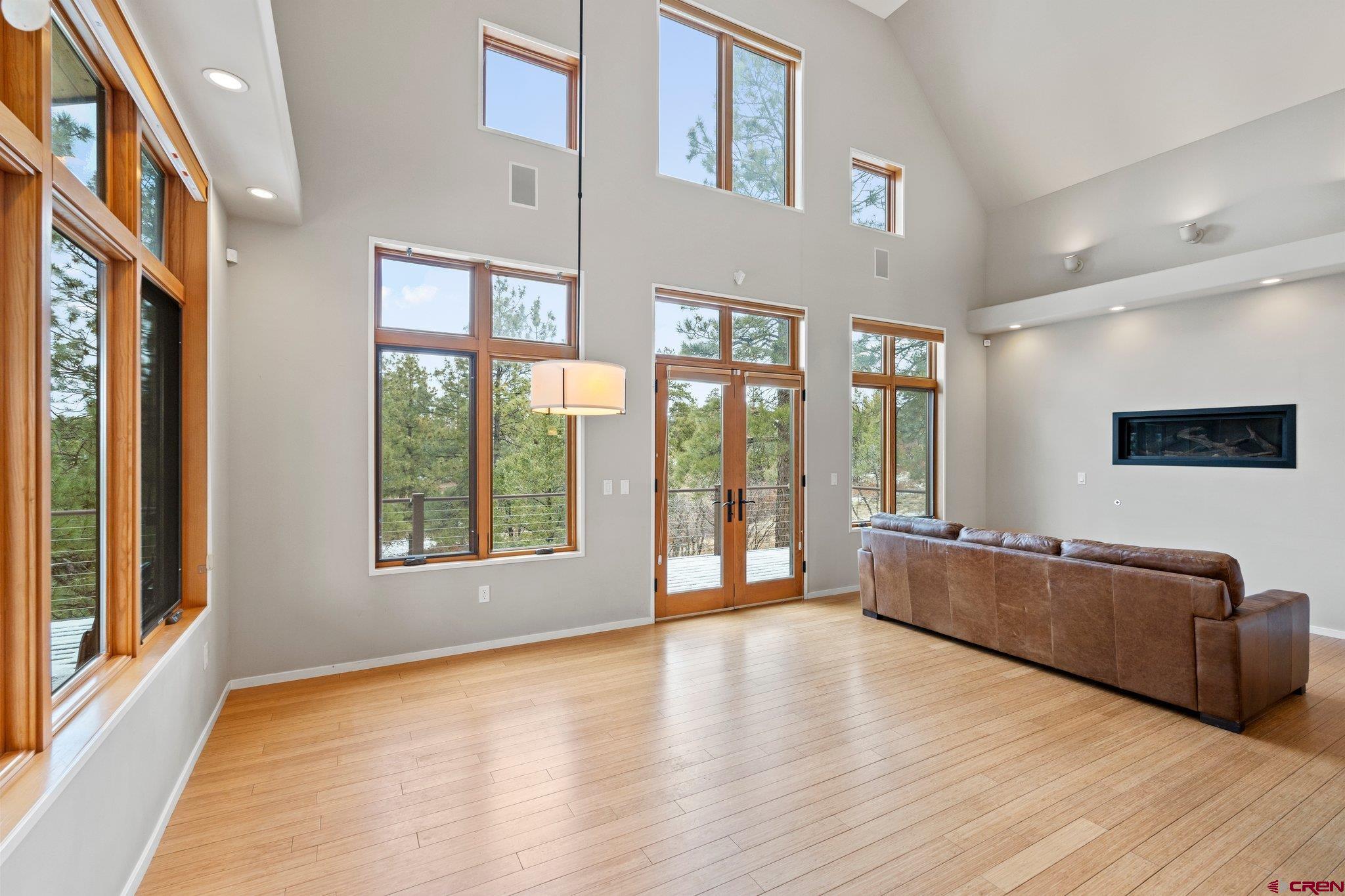 855 Ridge Road Durango, CO 81303 - Photo 3 of 35 a view of an empty room with wooden floor and a window