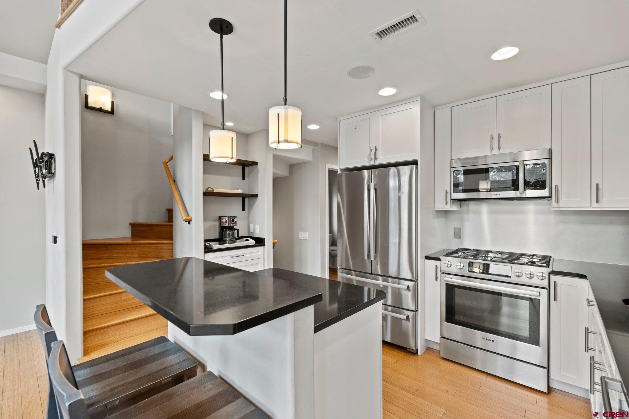 855 Ridge Road Durango, CO 81303 - Photo 6 of 35 a kitchen with kitchen island a counter appliances a sink and cabinets