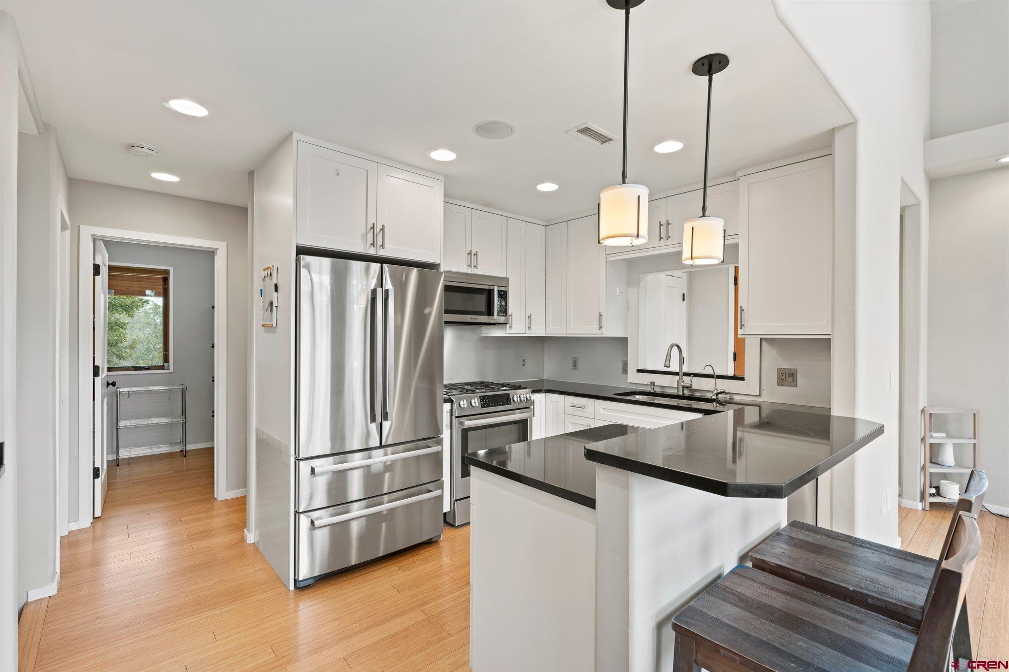 855 Ridge Road Durango, CO 81303 - Photo 7 of 35 a kitchen with stainless steel appliances granite countertop a refrigerator a sink and a stove