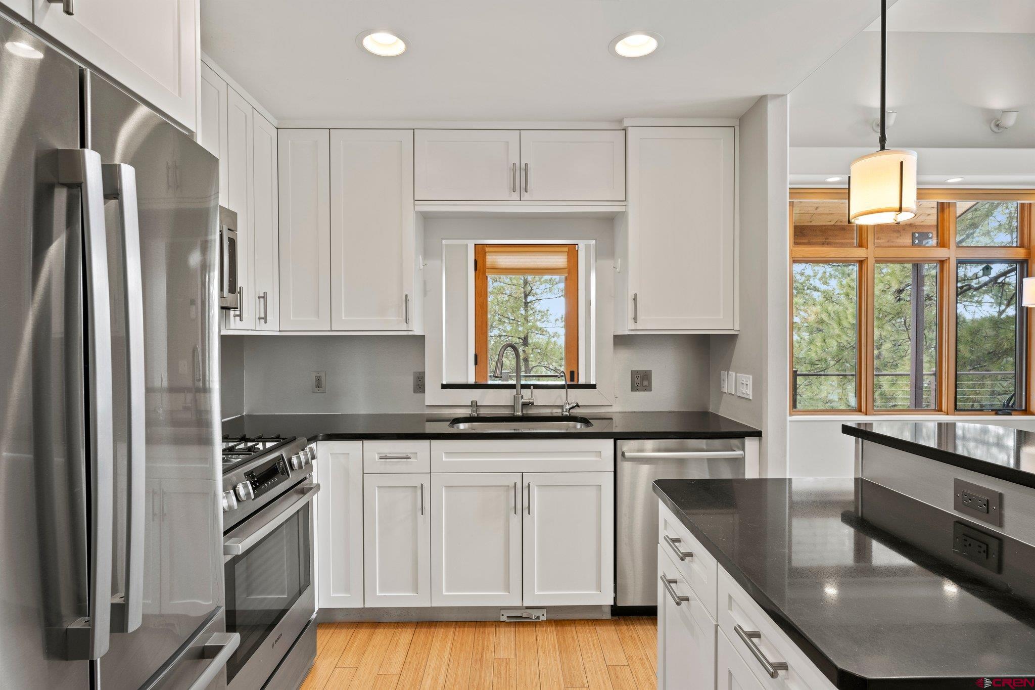 855 Ridge Road Durango, CO 81303 - Photo 8 of 35 a kitchen with stainless steel appliances granite countertop a sink a stove and refrigerator