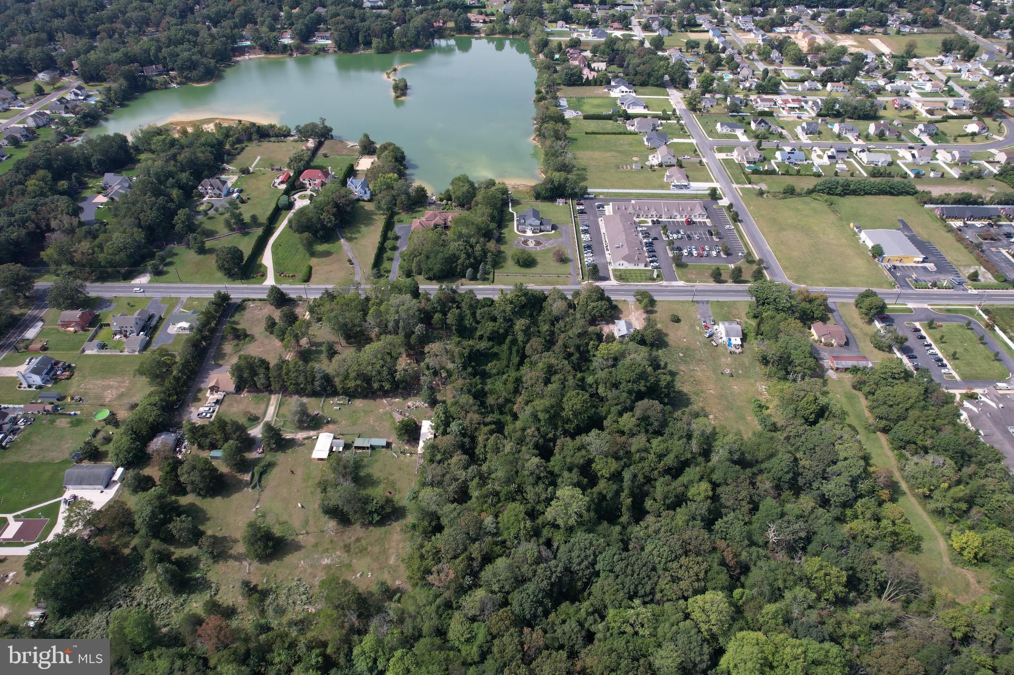 an aerial view of house with yard and lake view