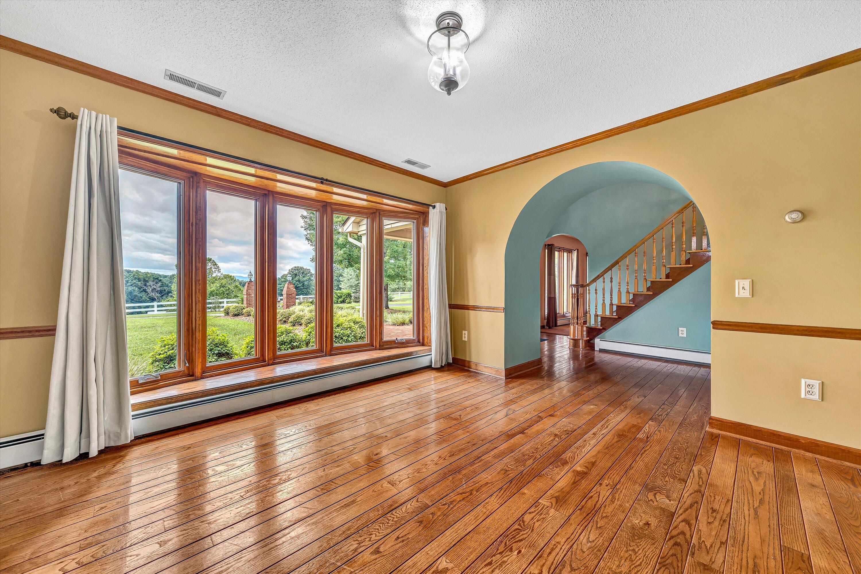 270 Parkside Lane Rocky Mount, VA 24151 - Photo 11 of 55 a view of empty room with wooden floor and fan