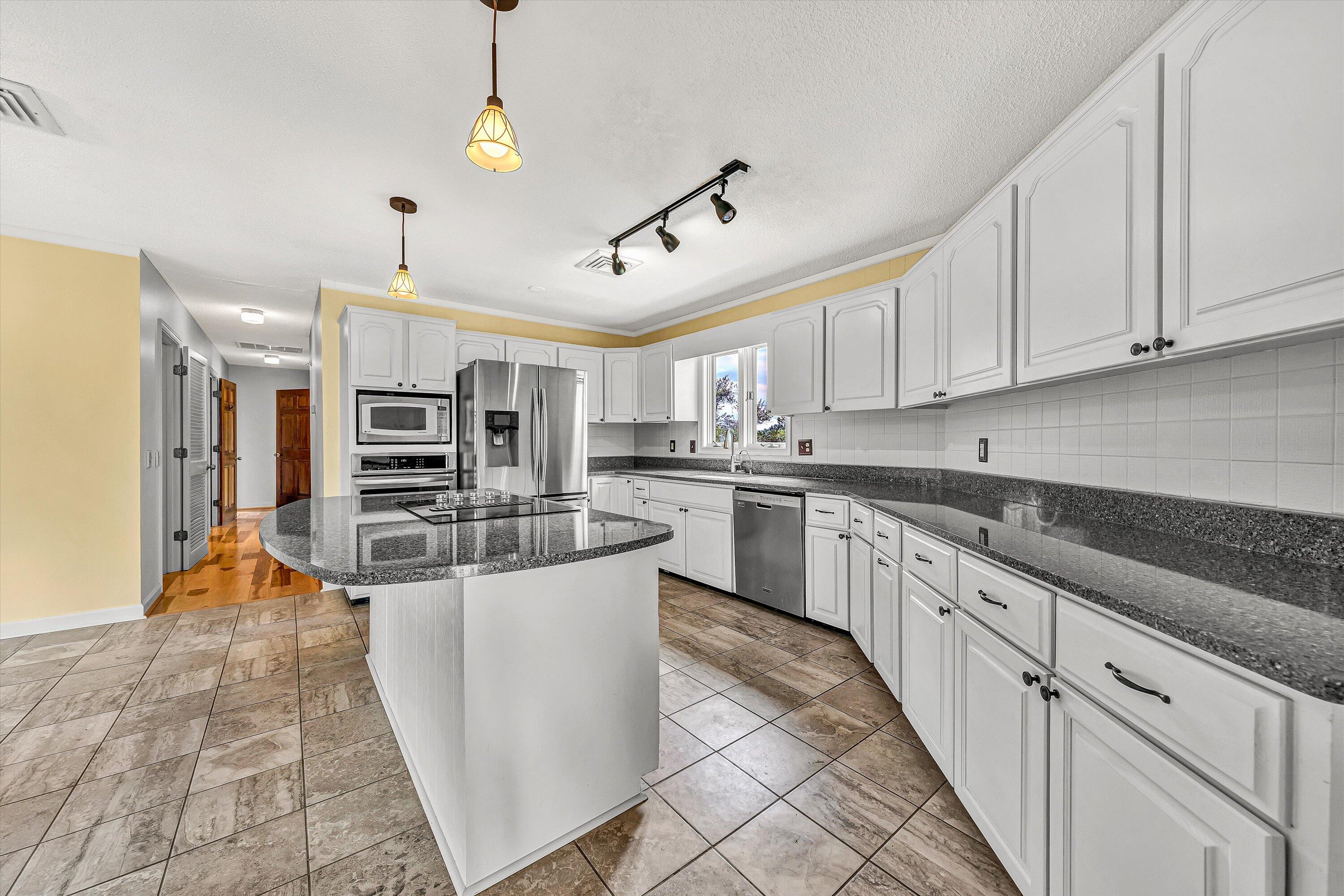270 Parkside Lane Rocky Mount, VA 24151 - Photo 17 of 55 a large kitchen with stainless steel appliances granite countertop a stove and a sink