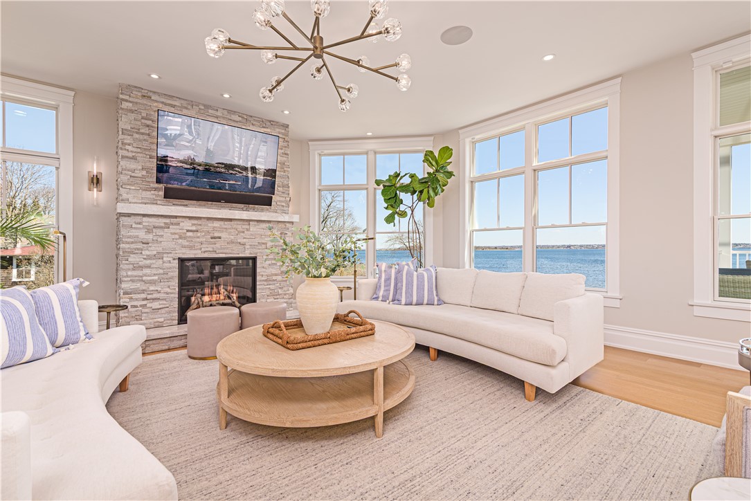 10 Coulter Street Jamestown, RI 02835 - Photo 11 of 48 Living room with gas fireplace and walls of windows to enjoy the breathtaking views of bridges and bay.