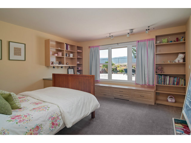 361 Ridgeway Road Woodside, CA 94062 - Photo 13 of 21 a bedroom with a bed and a large window