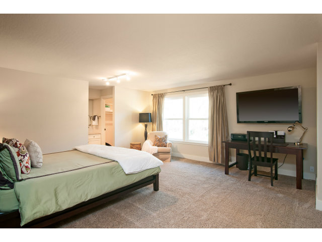 361 Ridgeway Road Woodside, CA 94062 - Photo 16 of 21 a bedroom with a bed and a flat screen tv