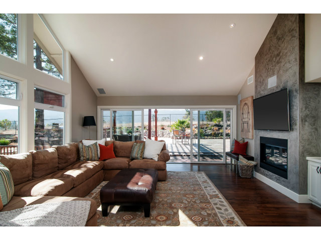 361 Ridgeway Road Woodside, CA 94062 - Photo 7 of 21 a living room with furniture fireplace and a large window