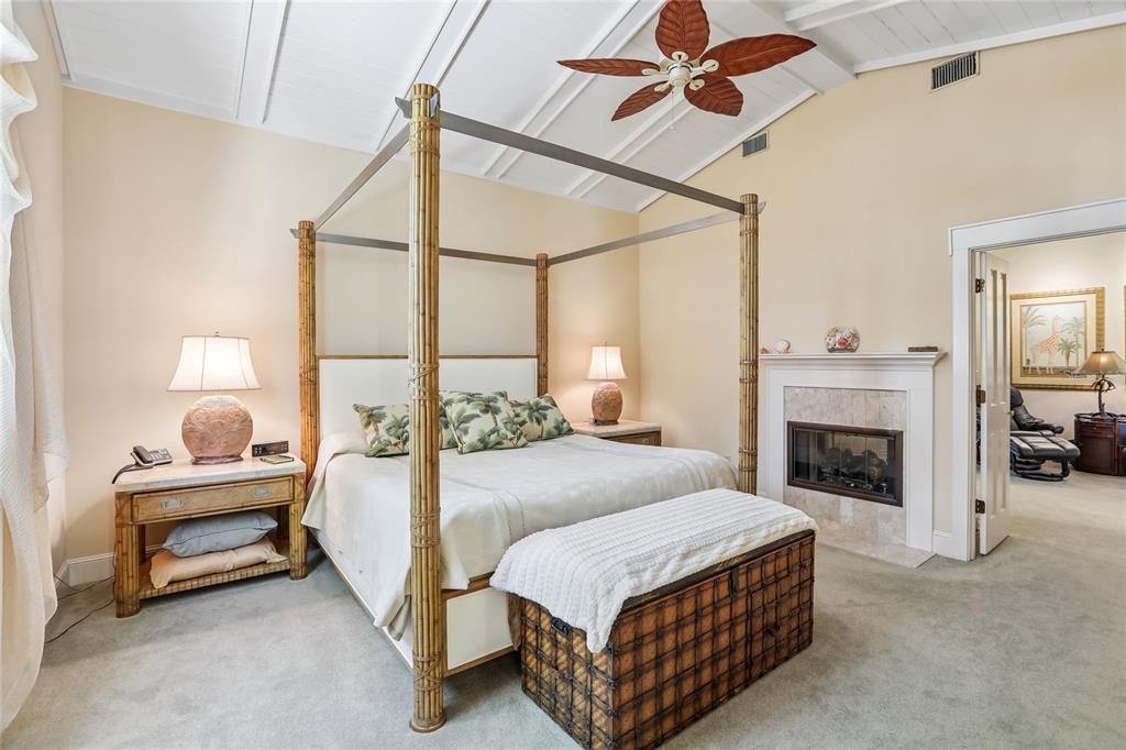 17810 Crawley Road Odessa, FL 33556 - Photo 39 of 76 a bedroom with a bed and a fireplace