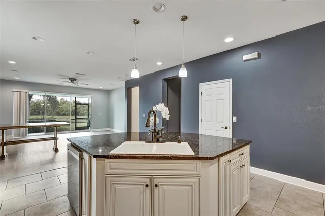 a kitchen with granite countertop a sink and a large mirror