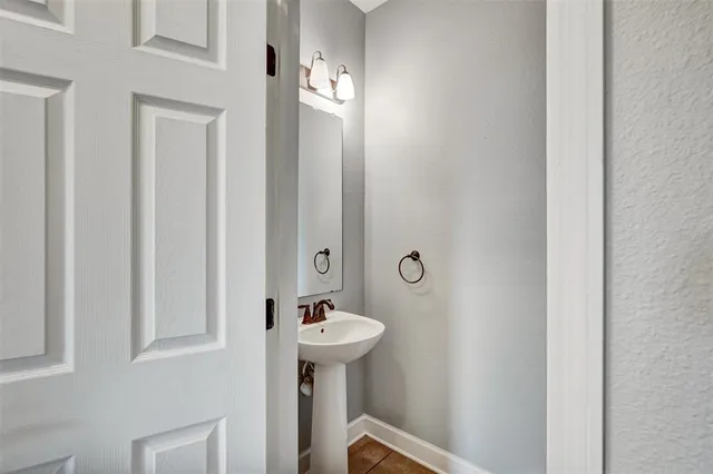 a bathroom with a sink and mirror