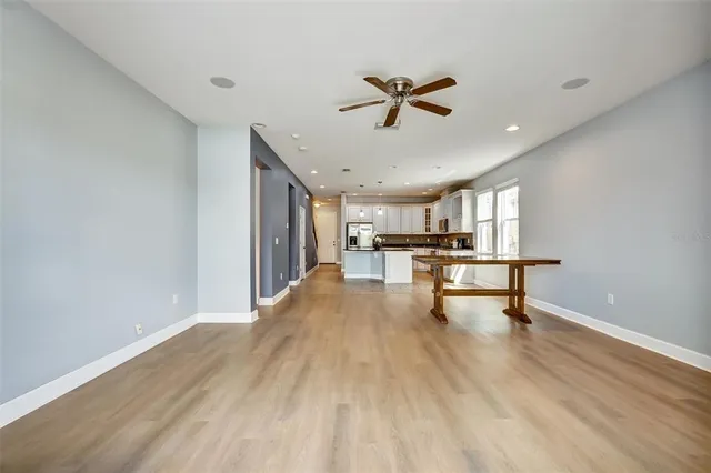 a view of a livingroom with a hardwood floor and a ceiling fan