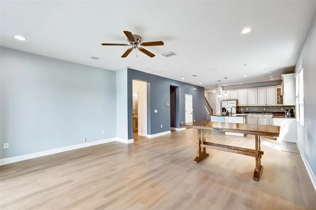 a view of a living room hardwood floor and a ceiling fan