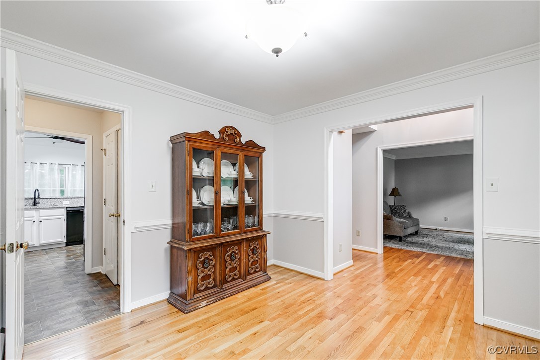5809 Rosebay Forest Road Midlothian, VA 23112 - Photo 8 of 48 a view of a hallway to a room with wooden floor and cabinet