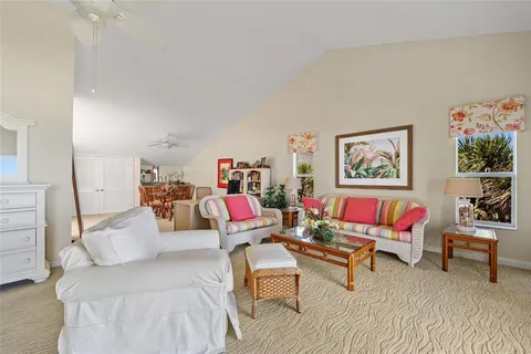 a living room with furniture and painting on the wall