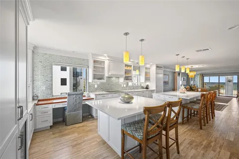 a large kitchen with a table and chairs