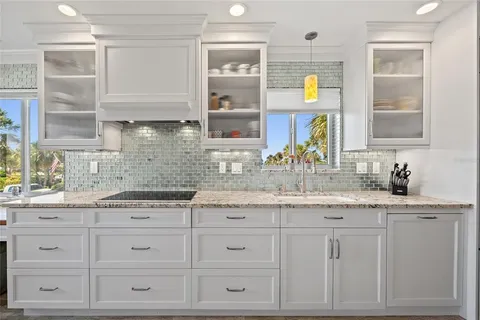 a kitchen with granite countertop a sink stainless steel appliances and cabinets