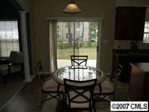 10516 Little Whiteoak Road Charlotte, NC 28215 - Photo 3 of 8 a view of a dining room with furniture window and outside view