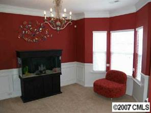 10516 Little Whiteoak Road Charlotte, NC 28215 - Photo 5 of 8 a kitchen with a chandelier and a fireplace