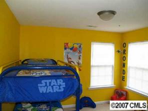 10516 Little Whiteoak Road Charlotte, NC 28215 - Photo 7 of 8 a bedroom with a bed and a window