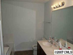 10516 Little Whiteoak Road Charlotte, NC 28215 - Photo 8 of 8 a bathroom with a sink a toilet and vanity