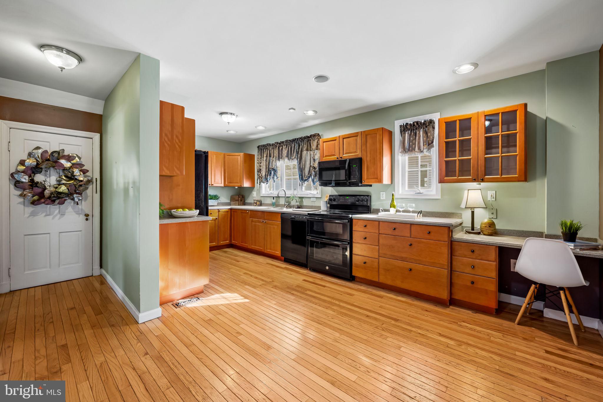 3022 Dunglow Road Baltimore, MD 21222 - Photo 11 of 45 a kitchen with stainless steel appliances kitchen island granite countertop a refrigerator a stove top oven and a sink