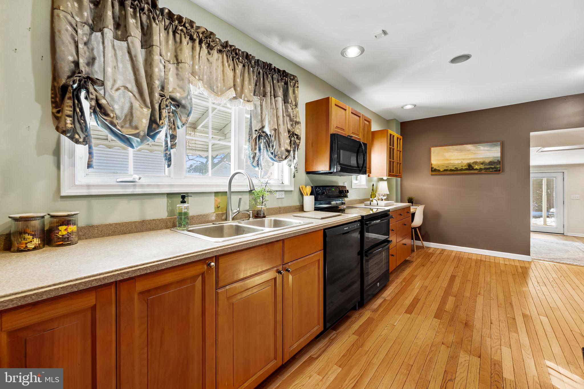 3022 Dunglow Road Baltimore, MD 21222 - Photo 13 of 45 a kitchen with a sink and wooden floor