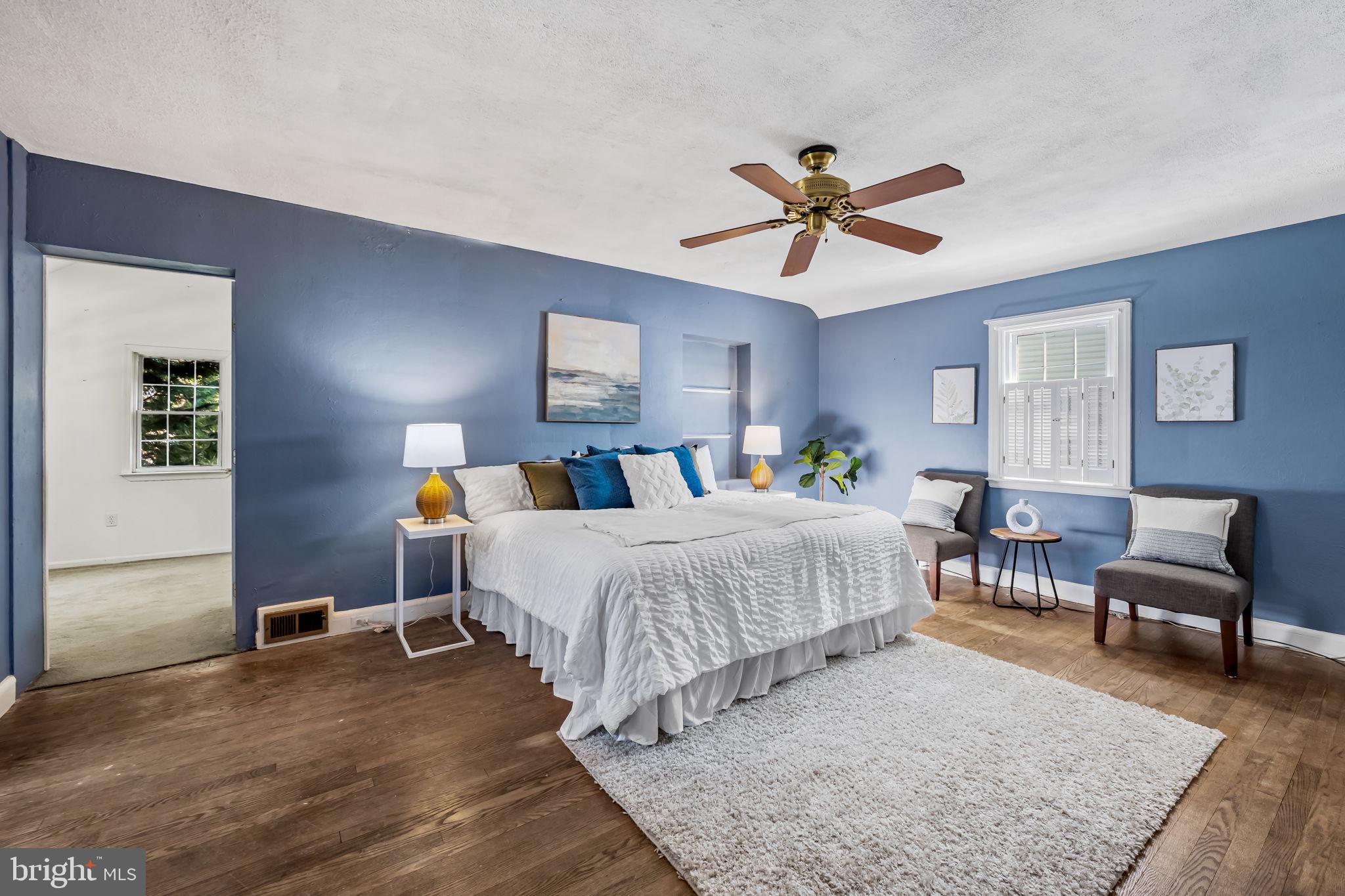 3022 Dunglow Road Baltimore, MD 21222 - Photo 22 of 45 a bedroom with a bed a chandelier and window