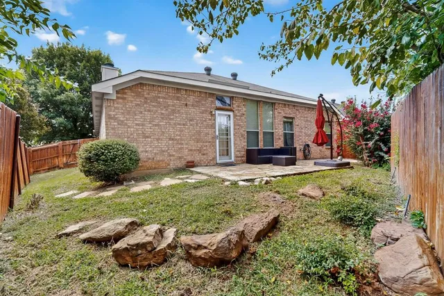 a backyard of a house with yard and outdoor seating