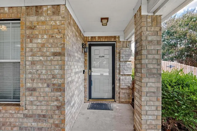 a brick building with a window and door