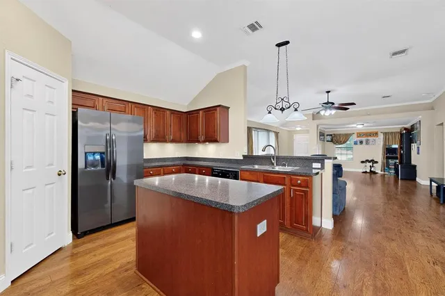 a kitchen with stainless steel appliances granite countertop a sink a counter space and stainless steel appliances