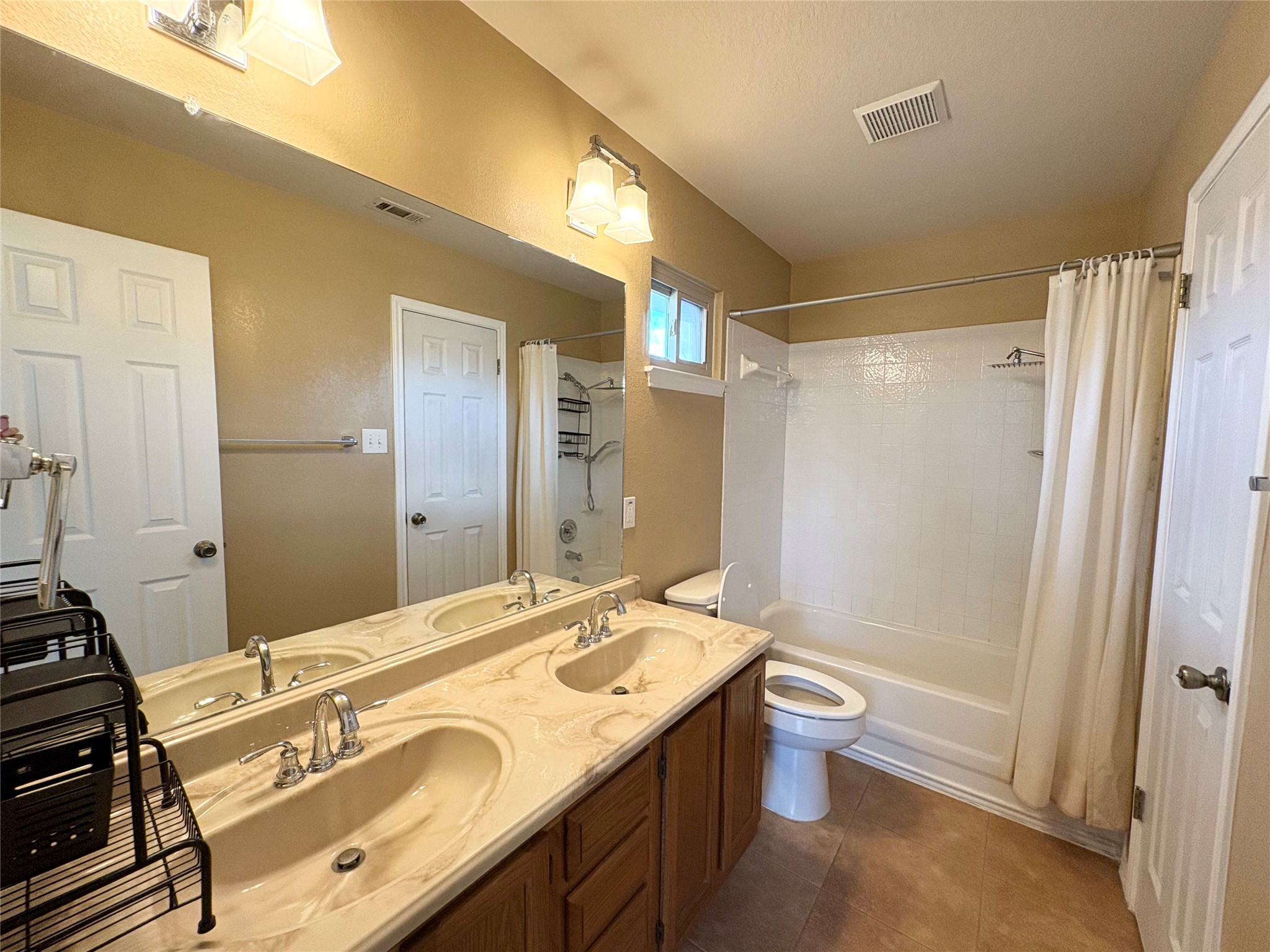 8103 Ephraim Road Austin, TX 78717 - Photo 27 of 35 Dual vanities with integrated sinks offer practical elegance in this functional bathroom.