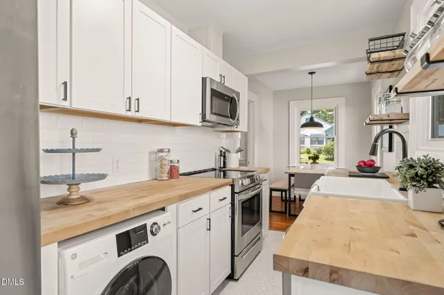 a kitchen with stainless steel appliances granite countertop a sink stove and cabinets