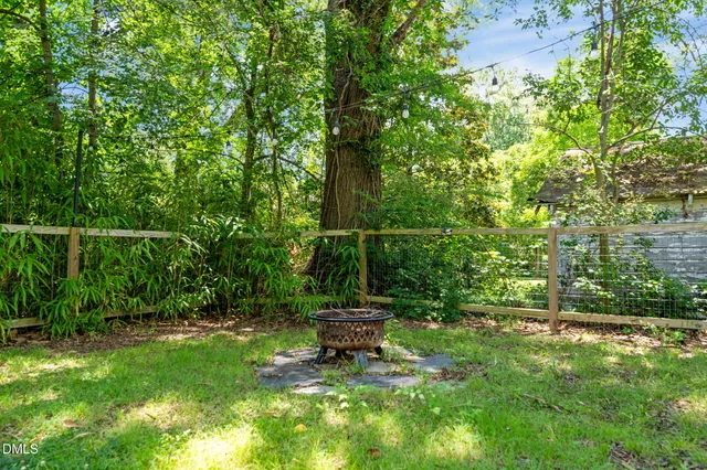 a backyard of a house with a table and plants